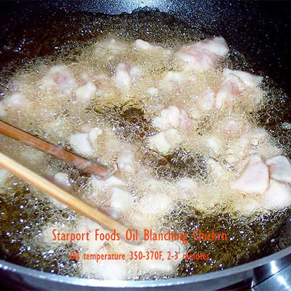 Image of marinated chicken being velvetized in frying oil.